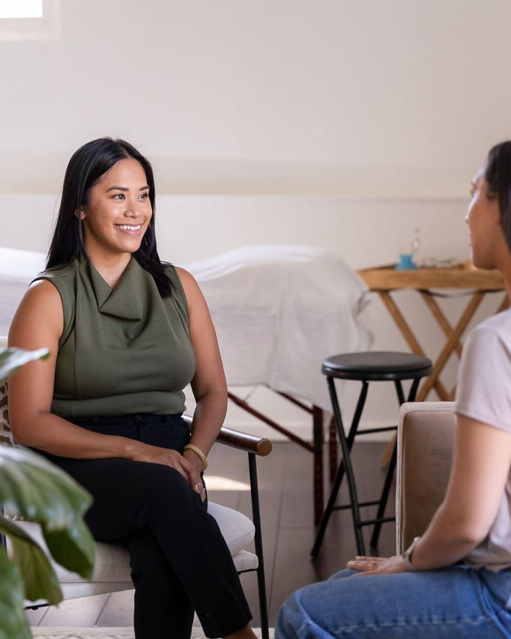 Dr. Monee Dulay listening to a client during a consultation