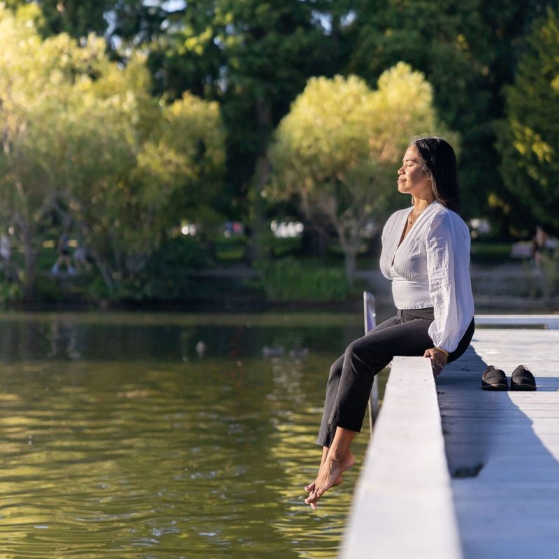 Dr. Monee relaxing on a dock by the water
