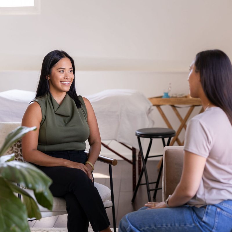 Dr. Monee talking with a client during a consultation Dr. Monee talking with a client during a consultation